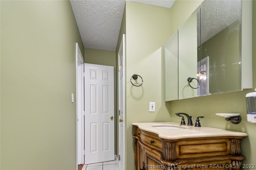 228 Overton Road Raeford, NC 28376 - Photo 14 of 23 a bathroom with a sink and a mirror