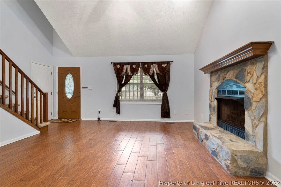 228 Overton Road Raeford, NC 28376 - Photo 3 of 23 a view of empty room with wooden floor and fireplace