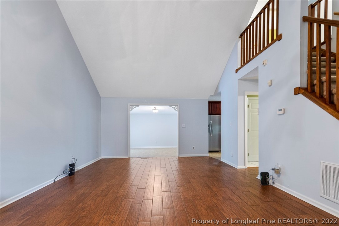 228 Overton Road Raeford, NC 28376 - Photo 5 of 23 a view of a hallway with wooden floor and staircase