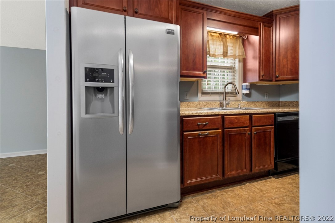 228 Overton Road Raeford, NC 28376 - Photo 10 of 23 a kitchen with stainless steel appliances granite countertop a refrigerator and a sink