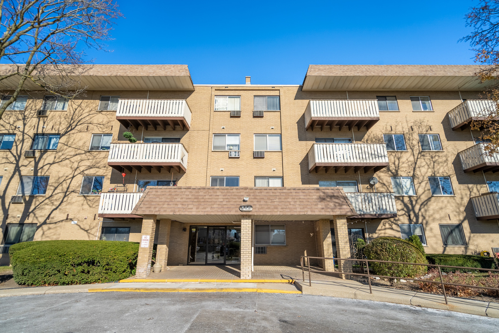 280 North Westgate Road, Unit 329 Mount Prospect, IL 60056 - Photo 1 of 2 a front view of a building with glass windows and a table