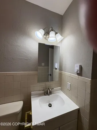 a bathroom with a sink toilet and mirror