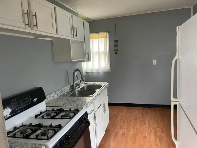 a kitchen with wooden cabinets and a stove top oven
