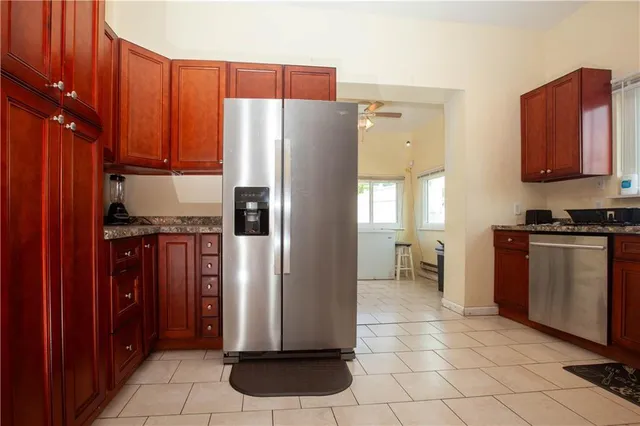 a kitchen with stainless steel appliances granite countertop a refrigerator and a stove
