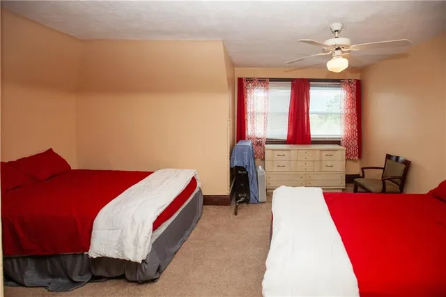 a living room with a bed furniture and a large window