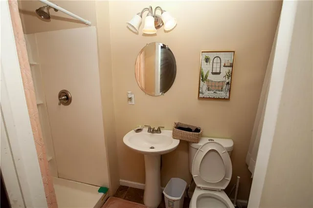 a bathroom with a toilet sink and mirror