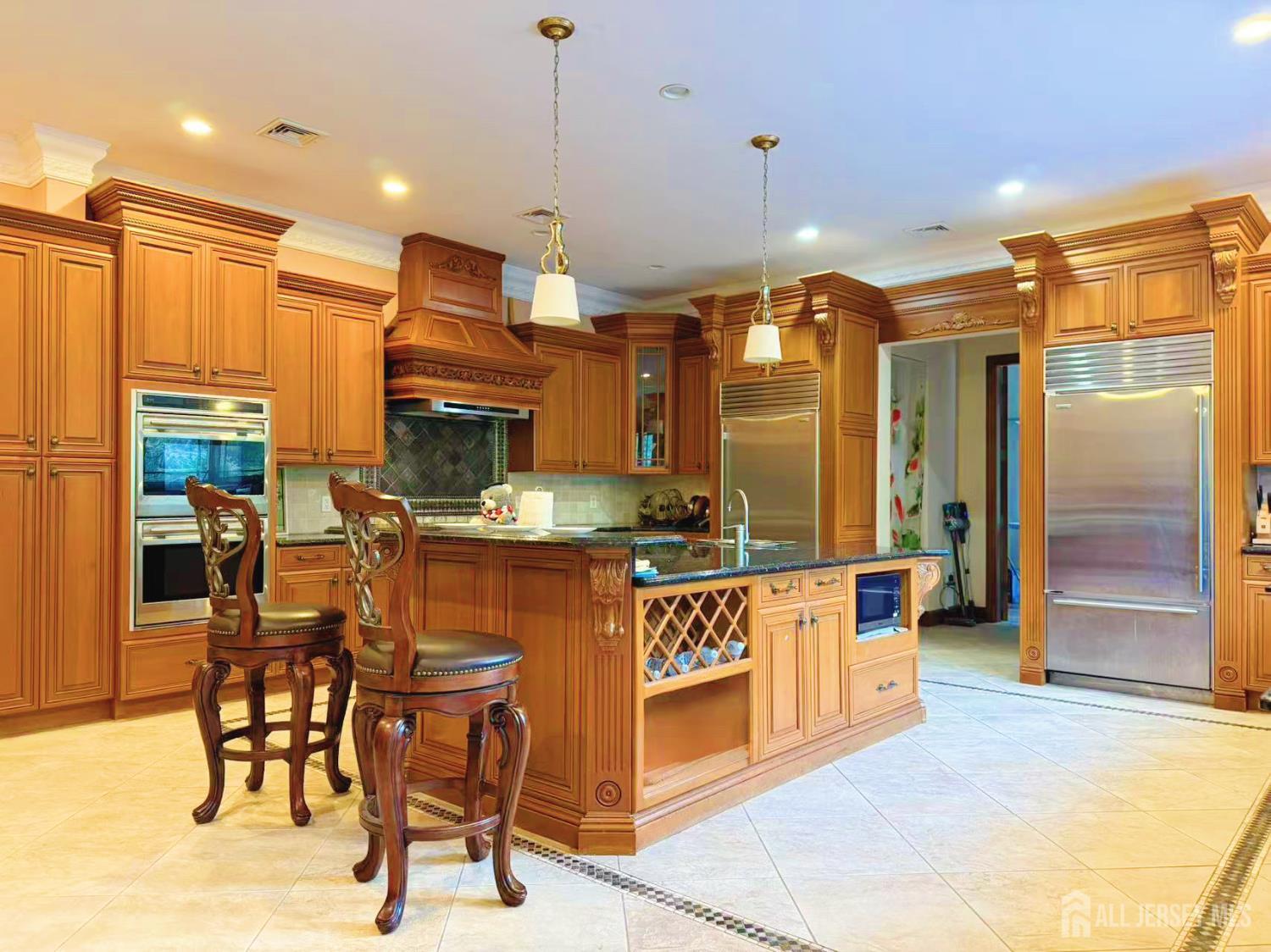 34 Line Road Holmdel, NJ 07733 - Photo 14 of 35 a kitchen with stainless steel appliances kitchen island granite countertop a table chairs and a refrigerator