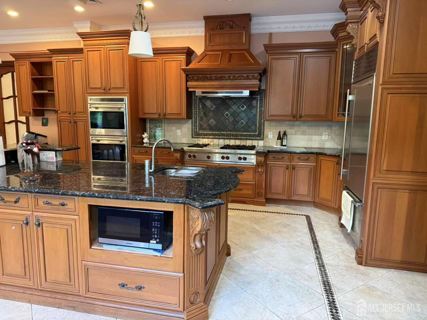 34 Line Road Holmdel, NJ 07733 - Photo 15 of 35 a kitchen with stainless steel appliances granite countertop a stove a sink and a microwave