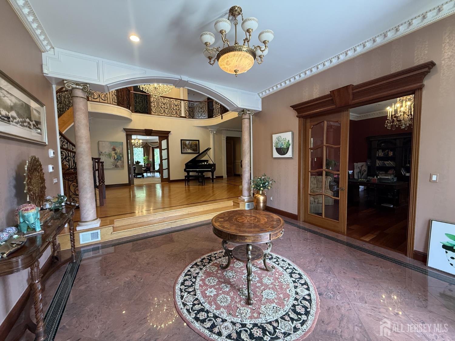34 Line Road Holmdel, NJ 07733 - Photo 2 of 35 a room with lots of furniture and a chandelier
