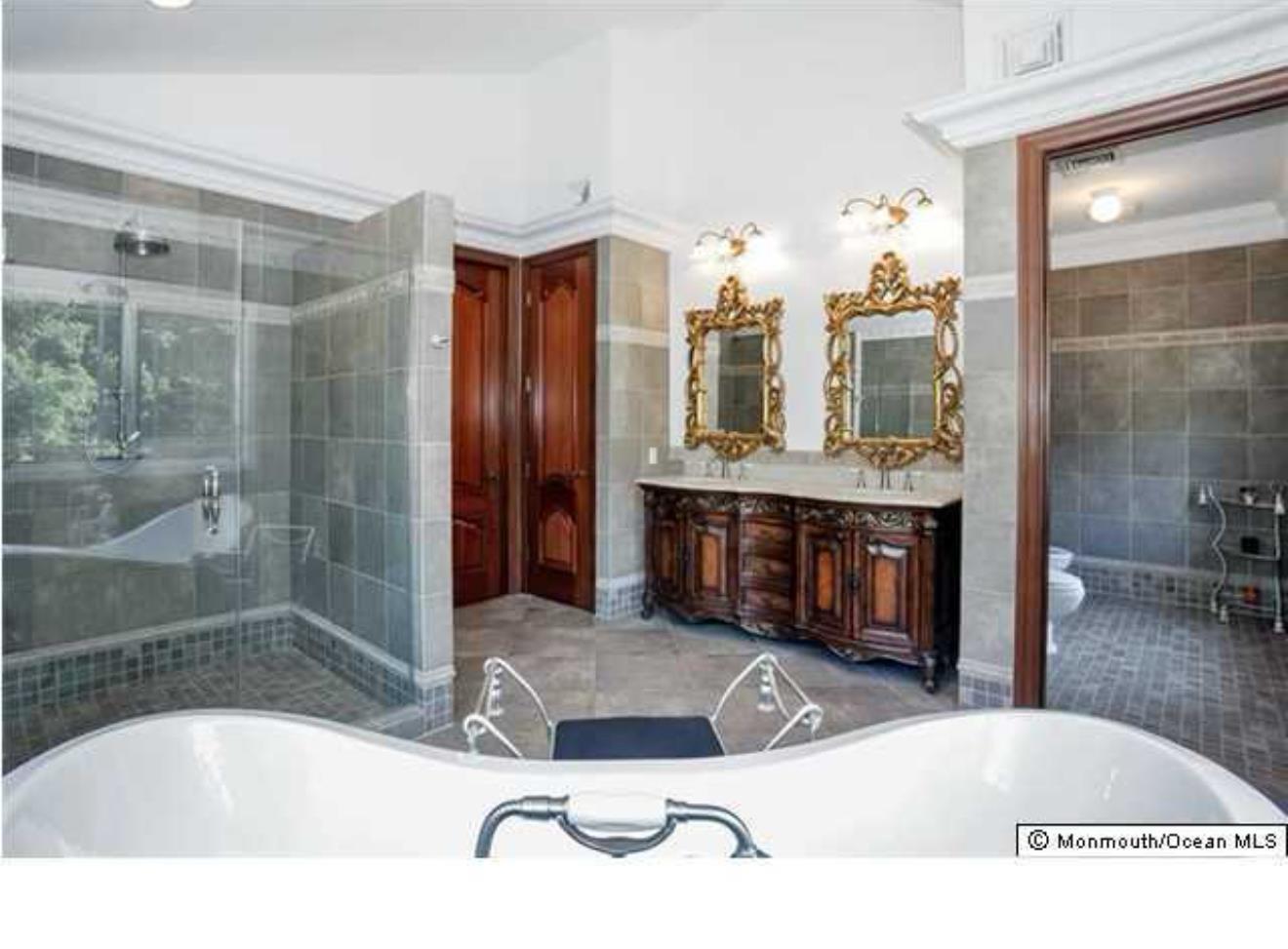 34 Line Road Holmdel, NJ 07733 - Photo 23 of 35 a bathroom with a tub sink and mirror