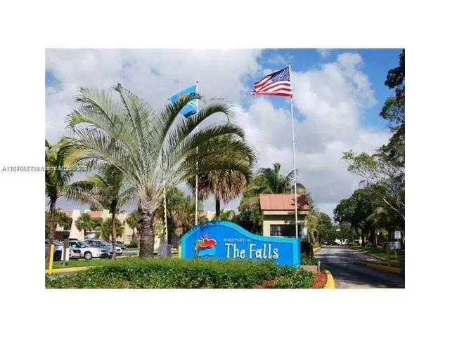 a picture of a park with plants and palm trees