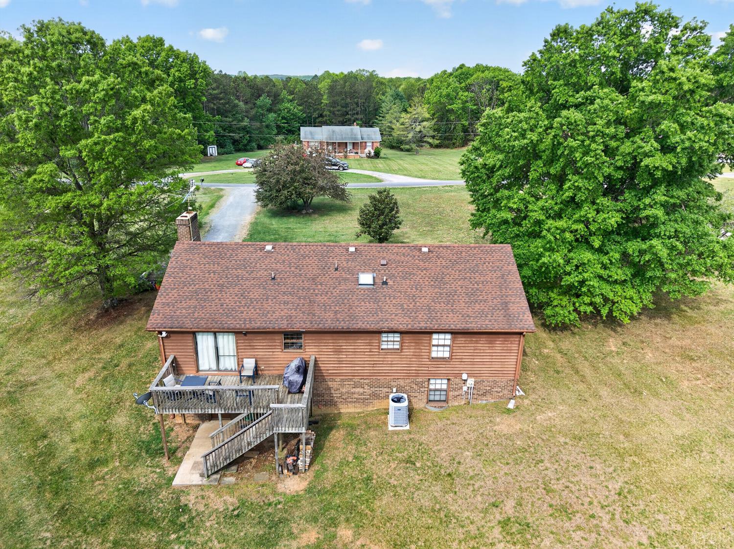 1002 Homeplace Road Rustburg, VA 24588 - Photo 44 of 48 an aerial view of a house with a garden and big trees