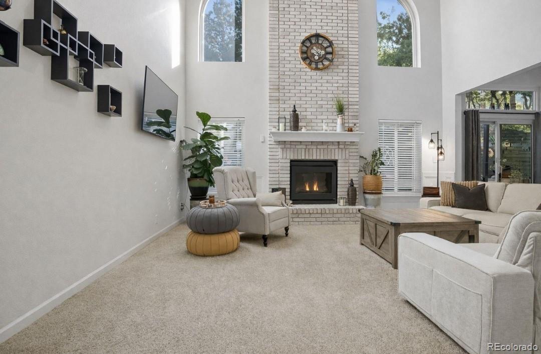 35 Ravenglass Way Colorado Springs, CO 80906 - Photo 2 of 45 a living room with furniture and a fireplace