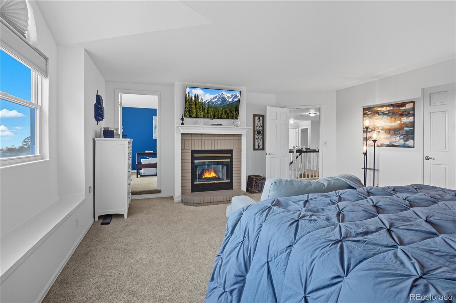 35 Ravenglass Way Colorado Springs, CO 80906 - Photo 26 of 45 a bed room with a bed and a fireplace