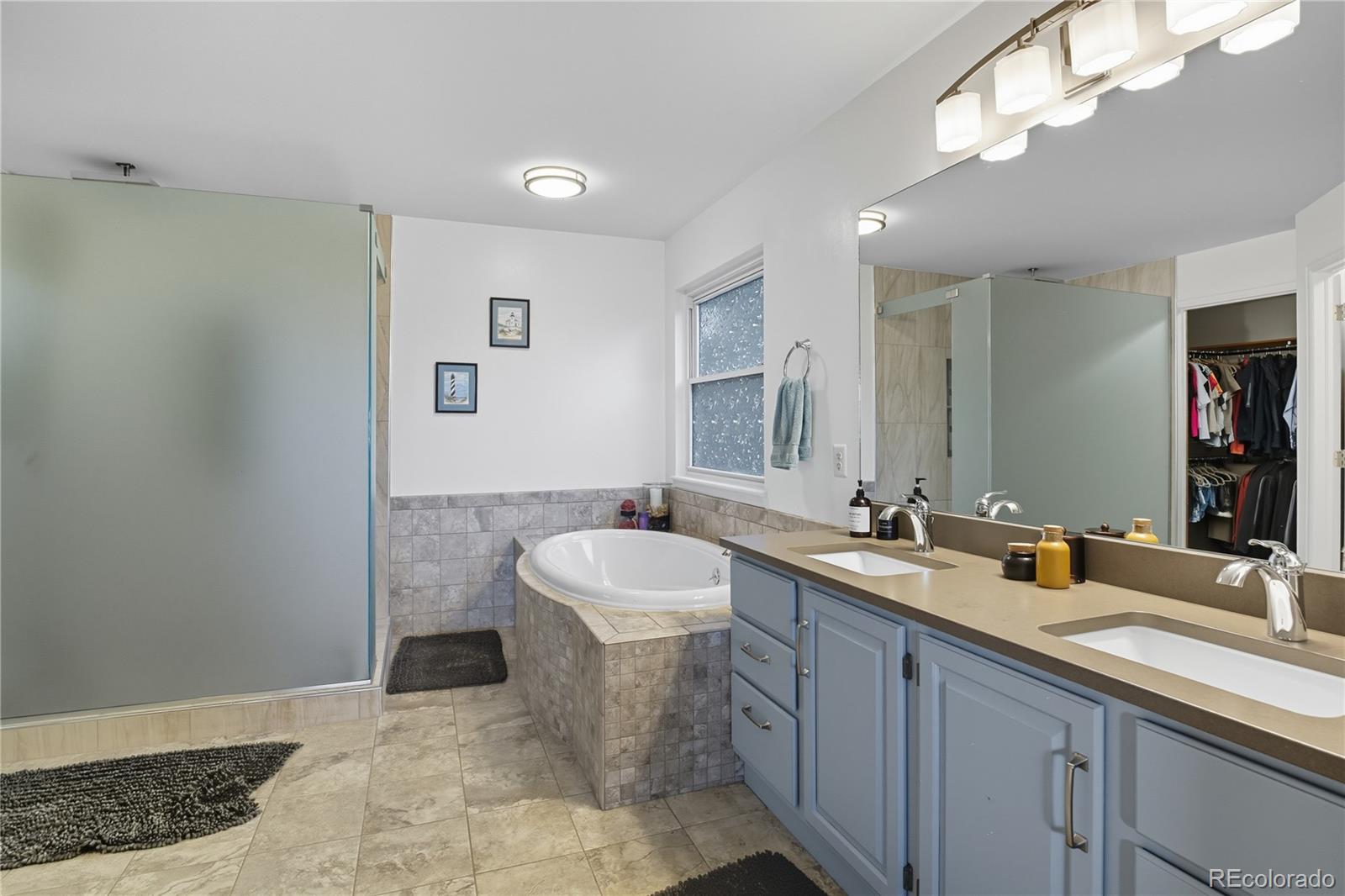 35 Ravenglass Way Colorado Springs, CO 80906 - Photo 27 of 45 a bathroom with a sink a toilet and a mirror