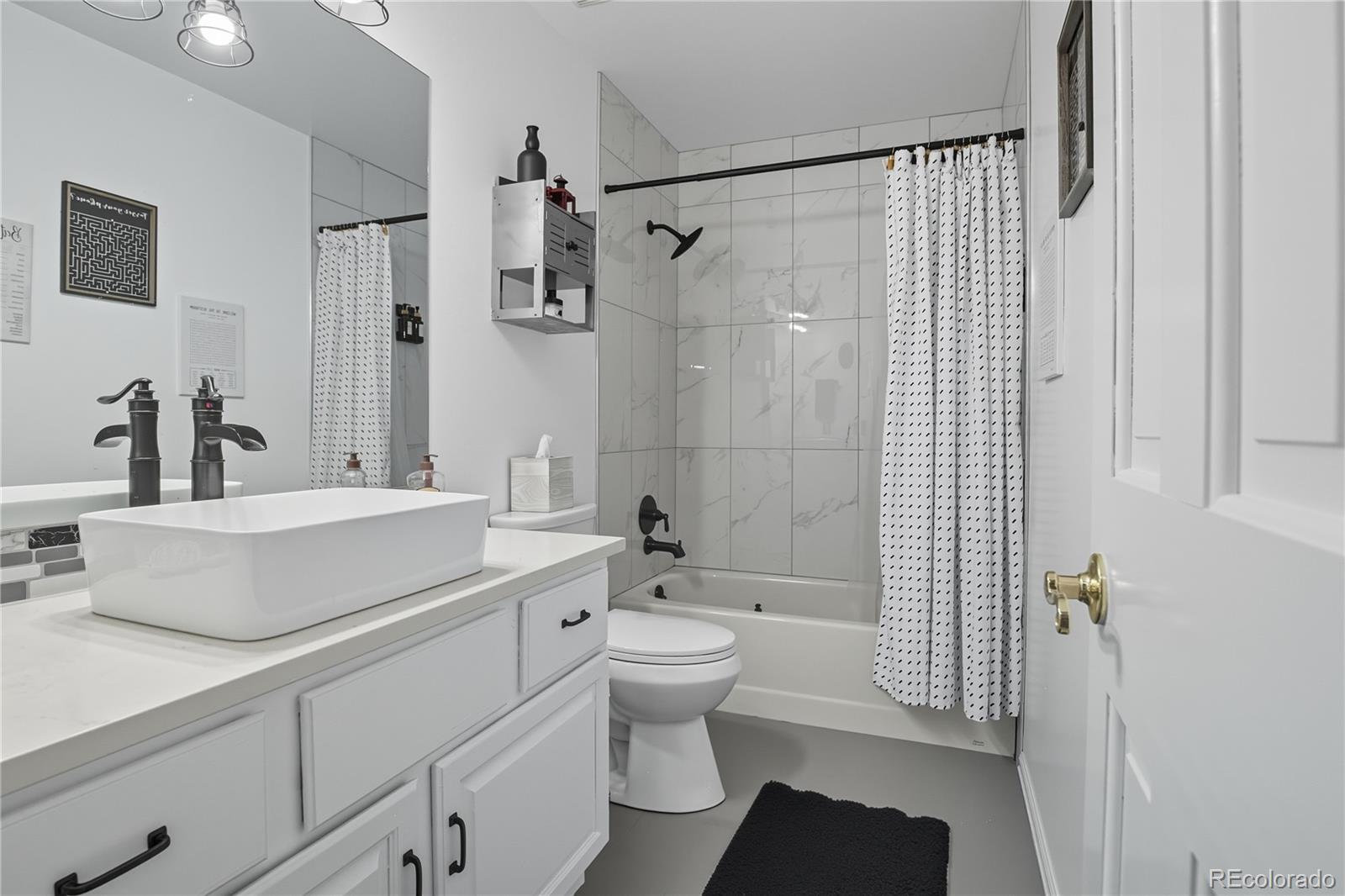 35 Ravenglass Way Colorado Springs, CO 80906 - Photo 35 of 45 a bathroom with a sink toilet vanity and shower