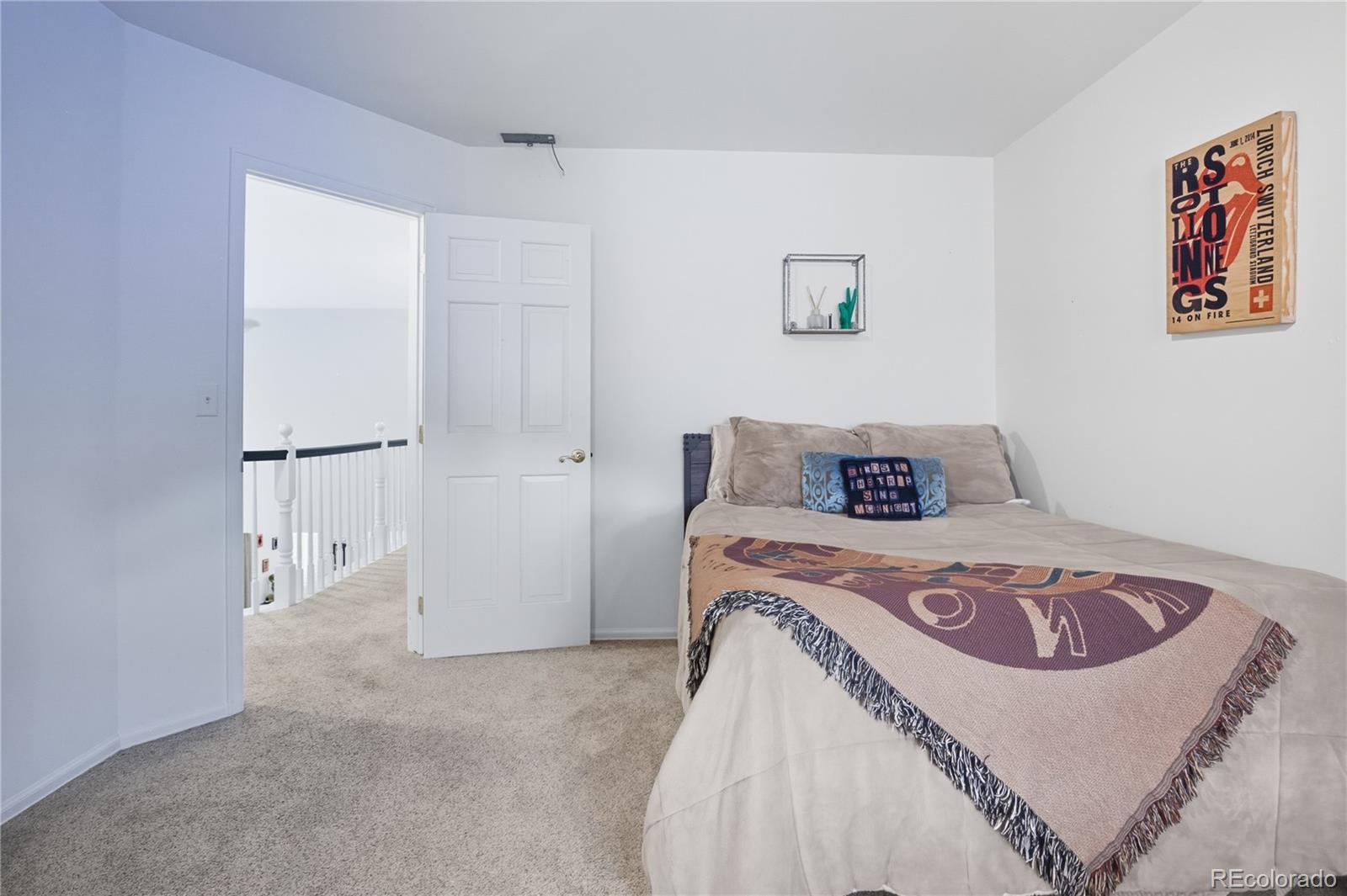35 Ravenglass Way Colorado Springs, CO 80906 - Photo 37 of 45 a bedroom with a bed and a table in it