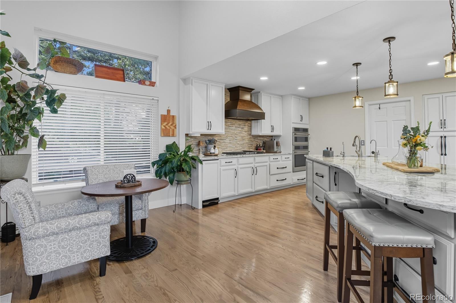 35 Ravenglass Way Colorado Springs, CO 80906 - Photo 5 of 45 a kitchen with furniture wooden floor and a table