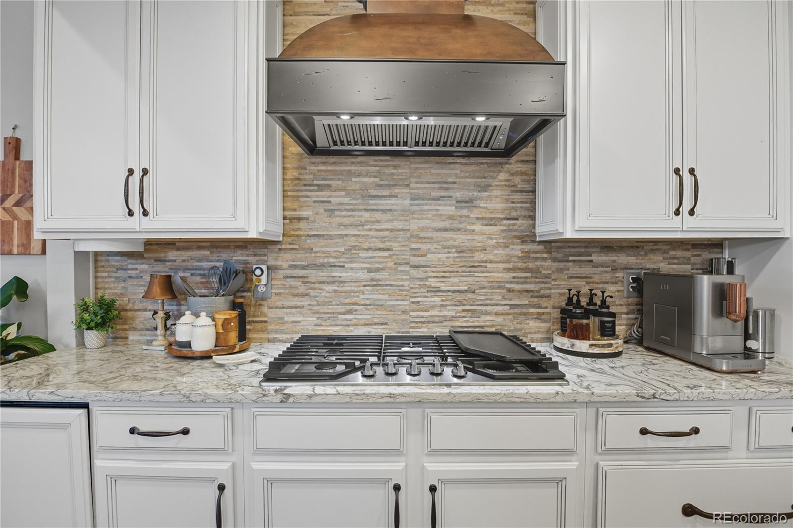 35 Ravenglass Way Colorado Springs, CO 80906 - Photo 7 of 45 a kitchen with granite countertop a stove sink and cabinets