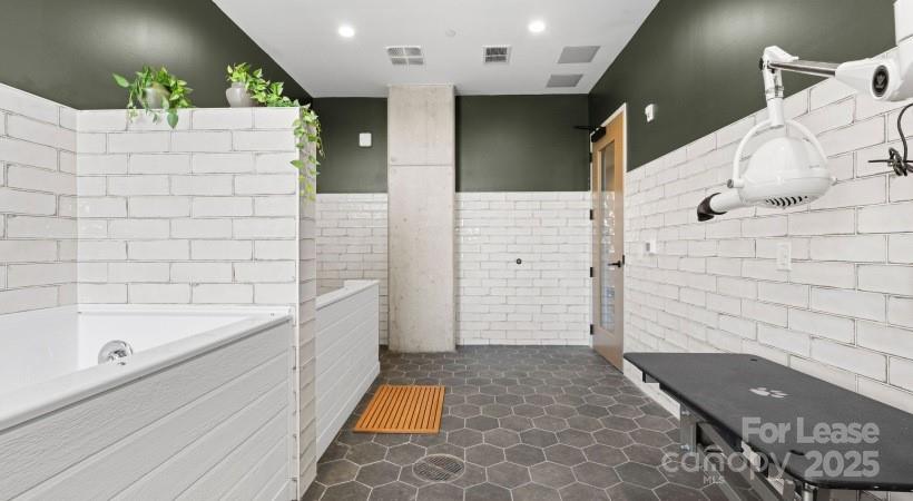 4312 Yancey Road, Unit B3 Charlotte, NC 28217 - Photo 11 of 48 a bathroom with a bathtub and shower