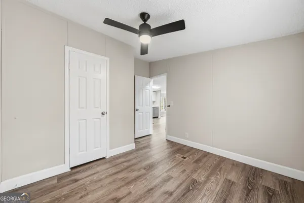 a view of an empty room and wooden floor