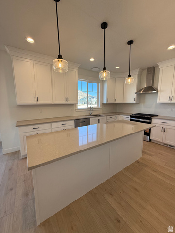 1142 West 220 North Mapleton, UT 84664 - Photo 6 of 26 Kitchen with electric range, white cabinets, light wood-style flooring, a center island, and hanging light fixtures