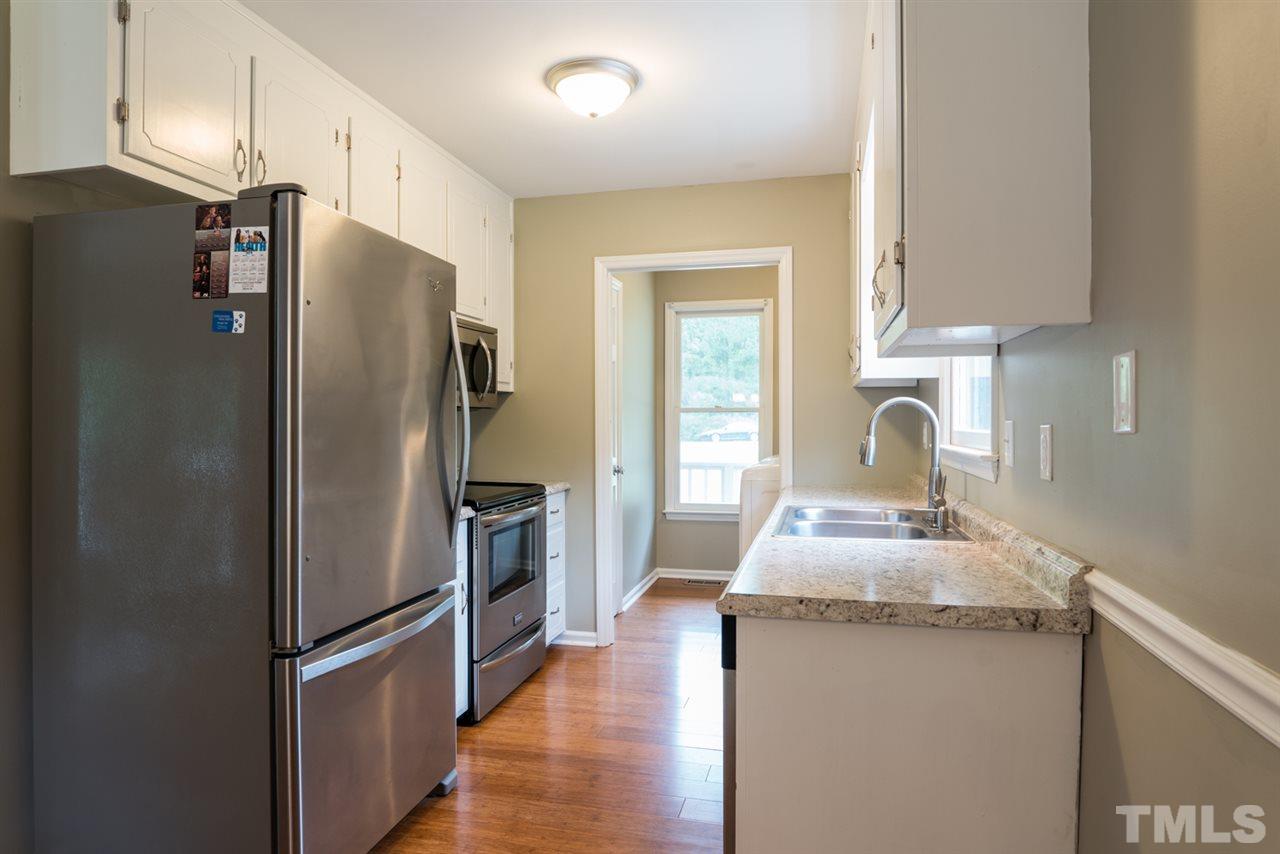 6016 Shadow Moss Circle Raleigh, NC 27603 - Photo 6 of 16 a kitchen with stainless steel appliances a refrigerator sink and stove