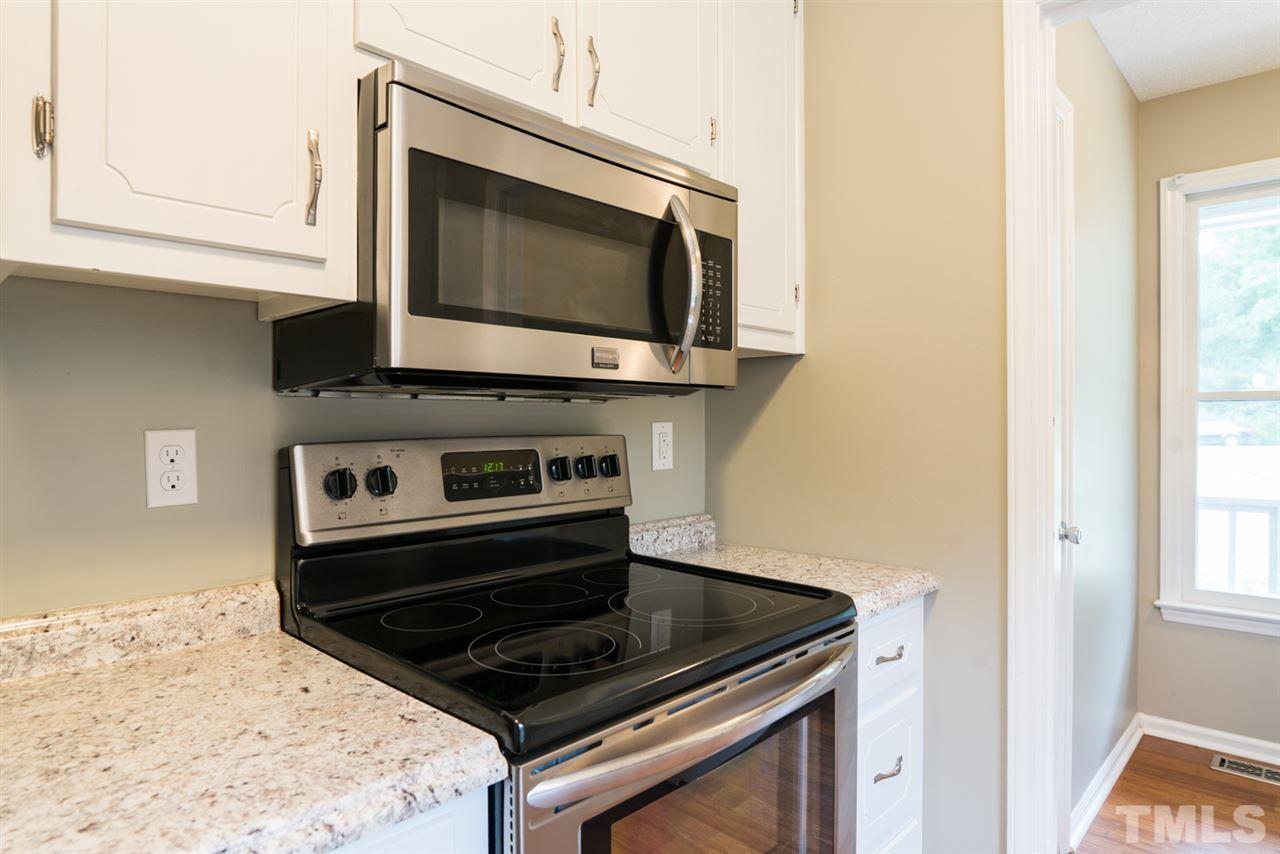 6016 Shadow Moss Circle Raleigh, NC 27603 - Photo 8 of 16 a kitchen with a stove and a microwave
