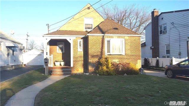 a view of house with yard and outdoor seating