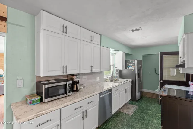 a bedroom with a bed and lamp on table