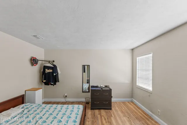 a bedroom with a bed and window