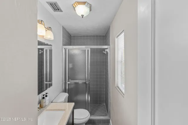 a view of a backyard with table and chairs and potted plants