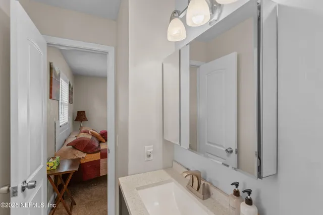 a view of a chair and table in back yard of the house