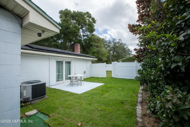 a view of a swimming pool with a yard
