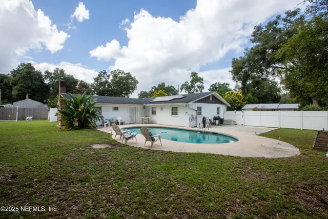 a front view of house with yard and green space