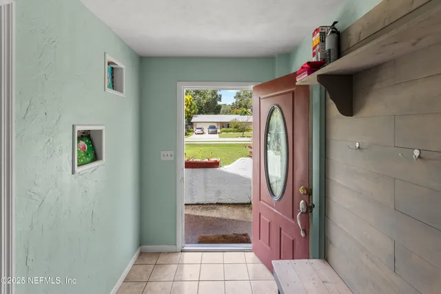 a living room with furniture a window and a ceiling fan