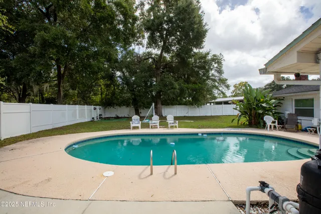 an aerial view of residential houses with city and outdoor space