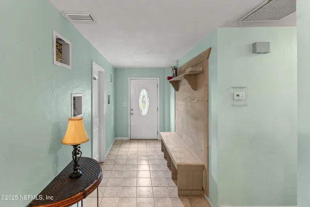 a living room with furniture and a floor to ceiling window