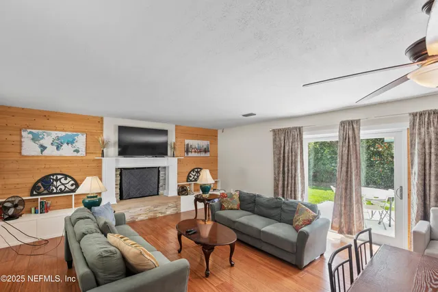 a kitchen with stainless steel appliances granite countertop a sink a stove and a refrigerator with white cabinets