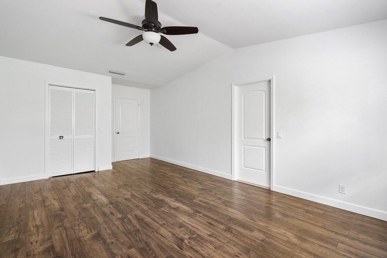 6684 Via Regina Boca Raton, FL 33433 - Photo 14 of 19 a view of empty room with wooden floor