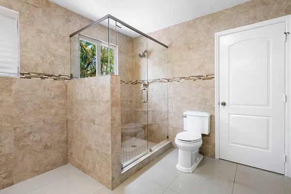 a bathroom with a shower and a toilet