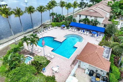 a view of a patio with table and chairs potted plants