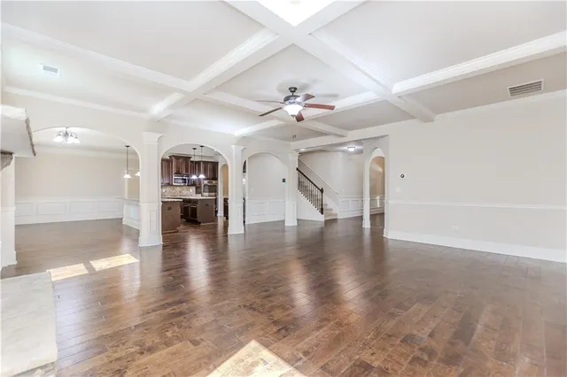 a kitchen with stainless steel appliances granite countertop a refrigerator a sink a stove and oven