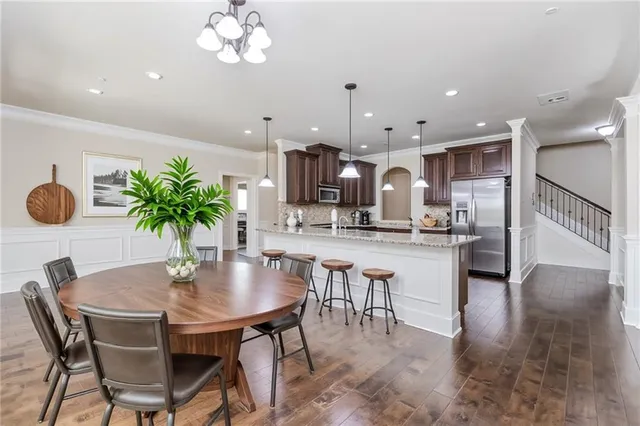 a bedroom with a large bed and a potted plant