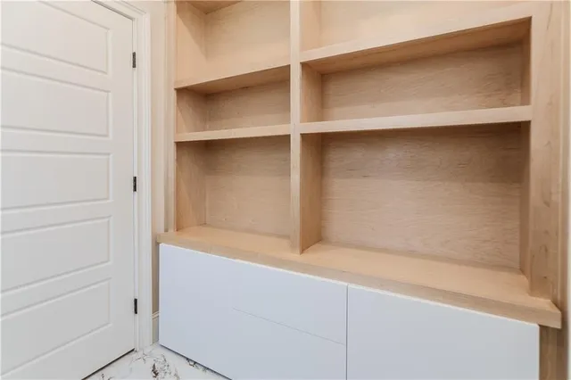 an empty room with an entrance to other room