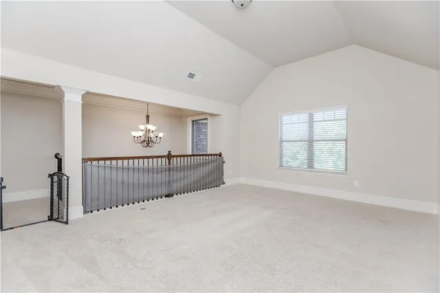 an aerial view of residential houses with outdoor space and trees