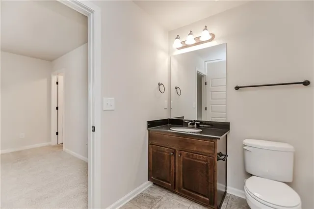 a front view of a house with a garden and trees