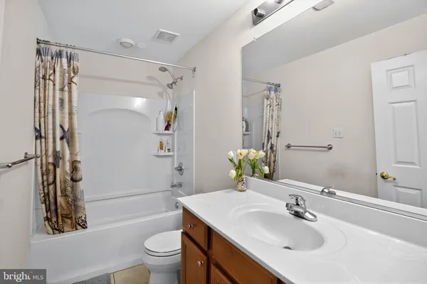 a bathroom with a sink toilet tub and shower