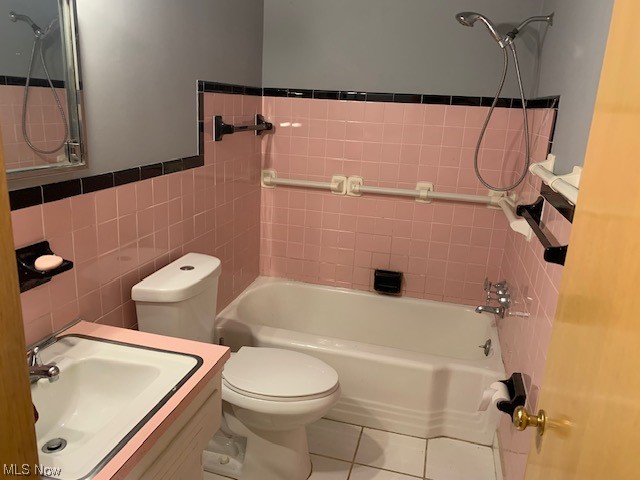 1767 Alcester Road Cleveland, OH 44124 - Photo 24 of 25 Full bathroom featuring vanity, mirror, tiled shower / bath, tile walls, and light tile floors