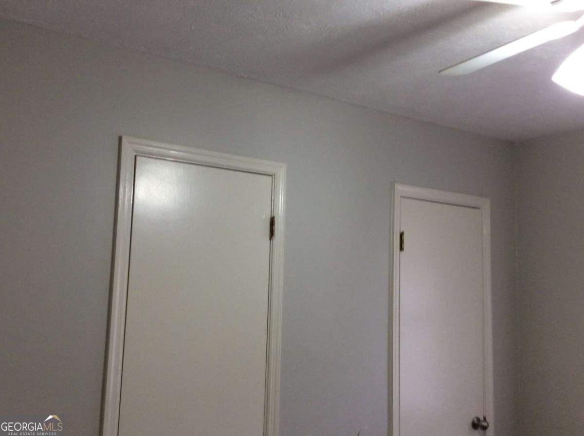 106 Richard Way Stockbridge, GA 30281 - Photo 12 of 15 a bathroom with a shower and a wooden door
